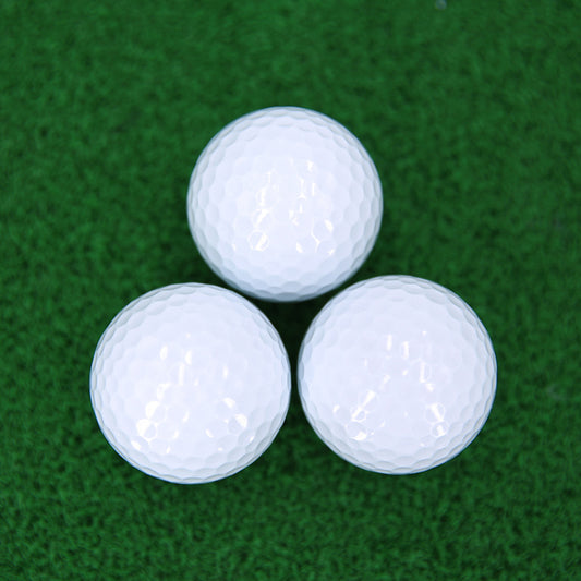 Three white golf balls