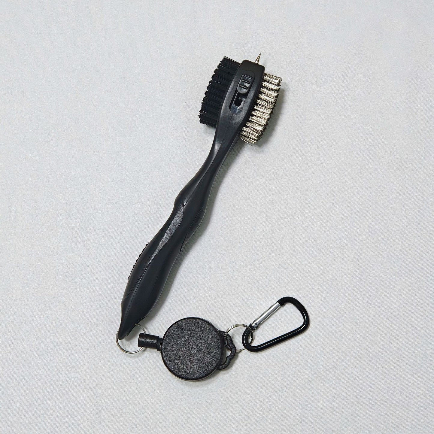 Retractable grill brush with black handle and silver bristle head 