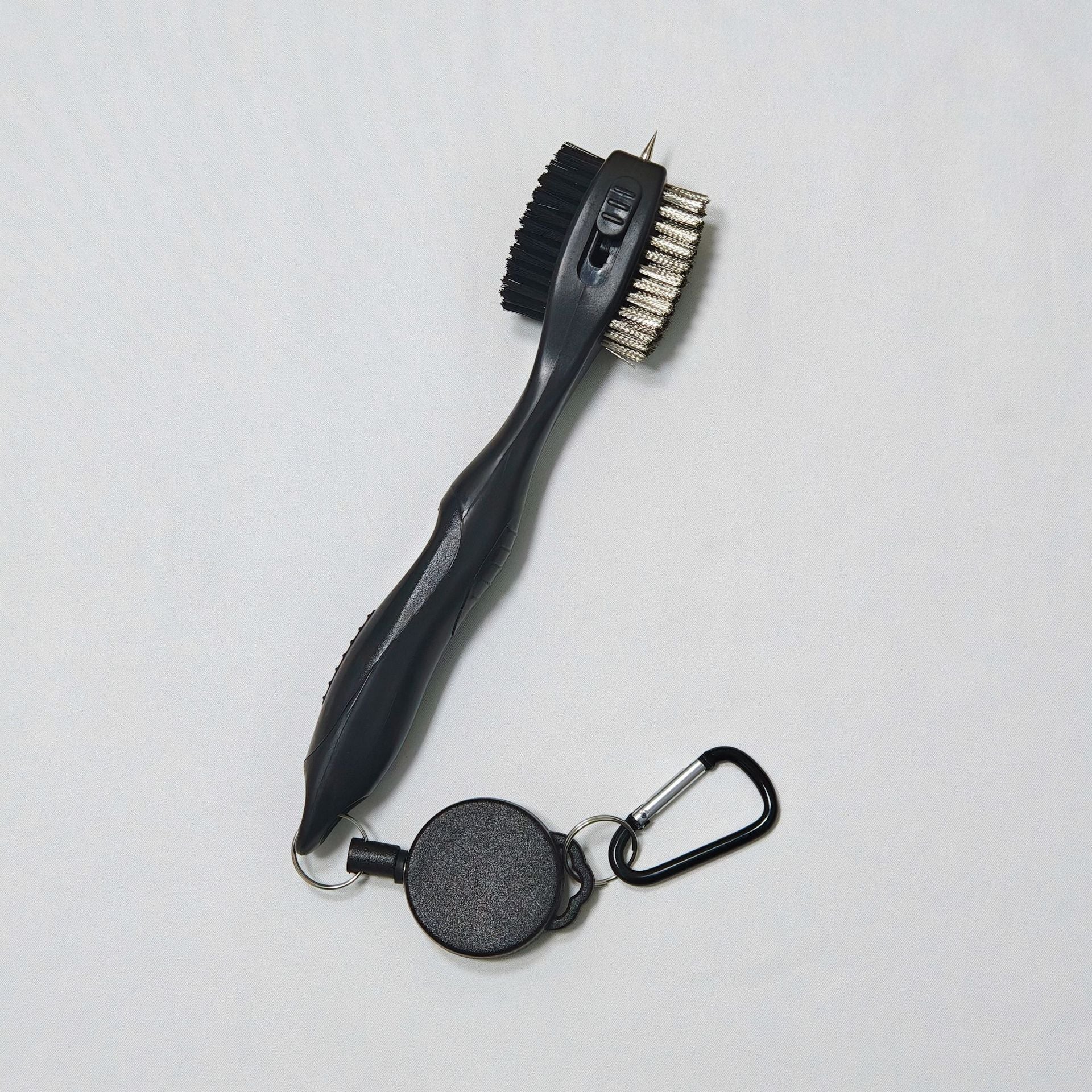 Retractable grill brush with black handle and silver bristle head 