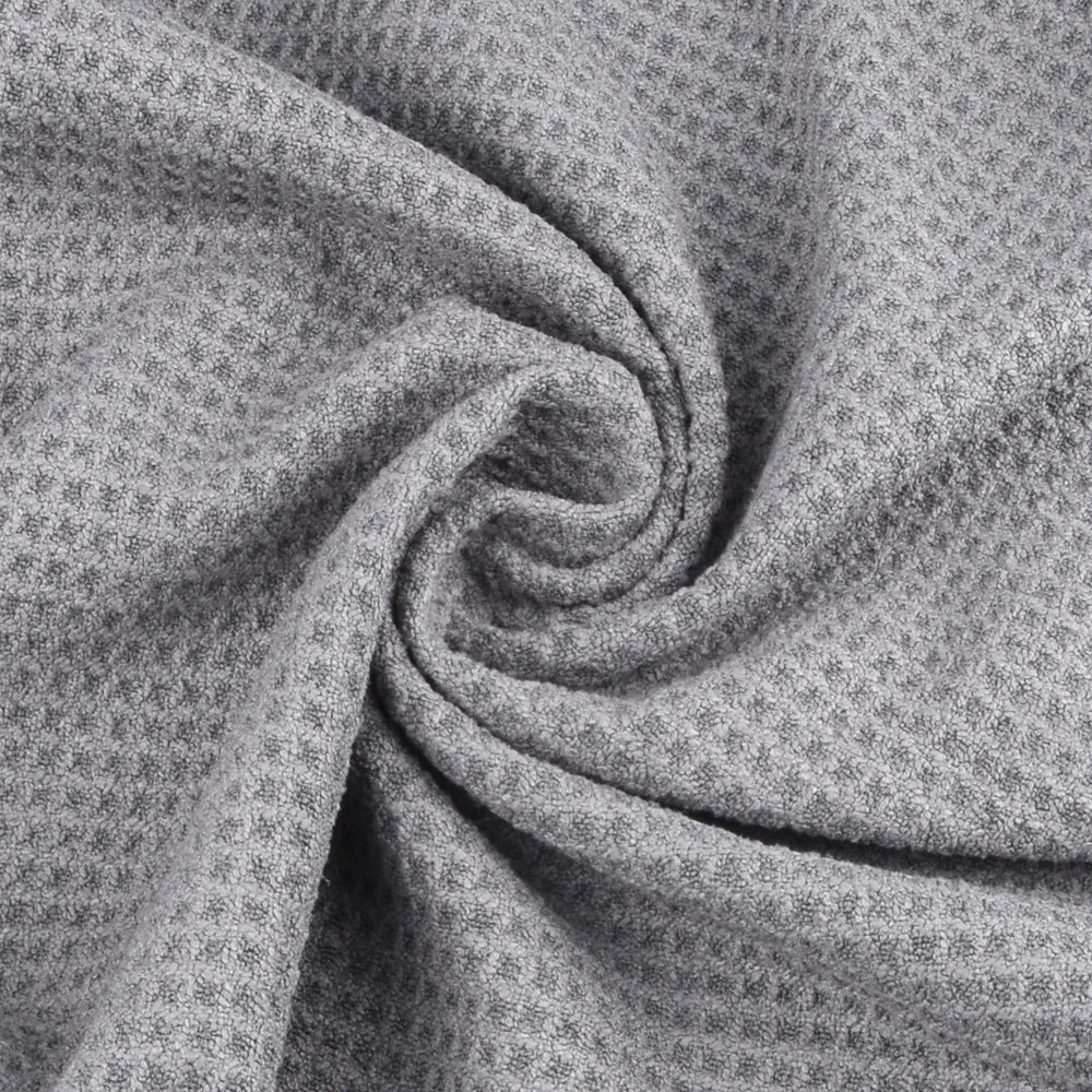 Close-up of gray textured fabric with a subtle pattern